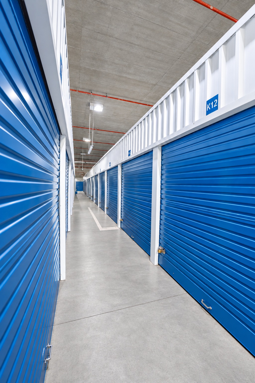 Blue roller-shutter units along aisle K12